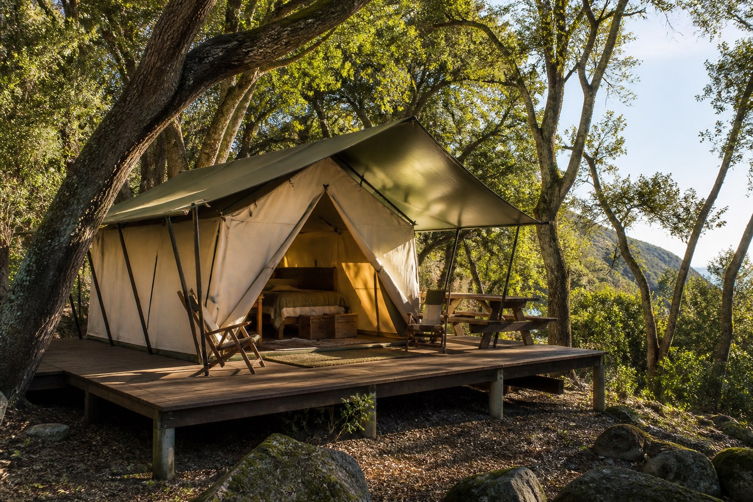 Luxury canvas safari tent on a wooden deck nestled among mature oak trees at El Capitan Canyon